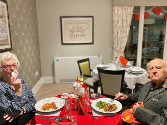 residents sat together enjoying a chinese meal