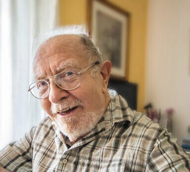 older man smiling in a care home
