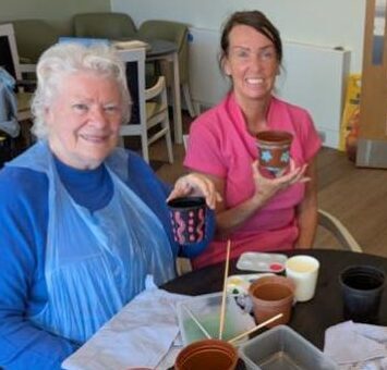 residents and staff potting plants
