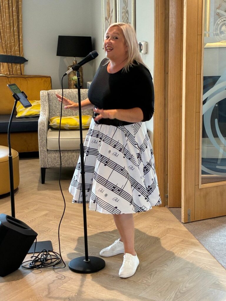 performer singing at sandmere care home